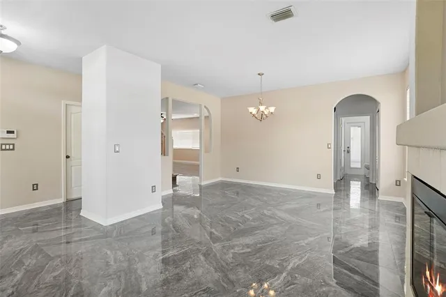 a view of empty room with a fireplace