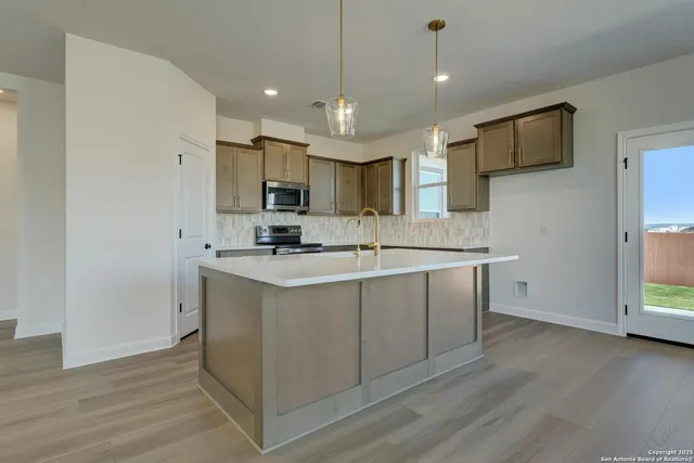a kitchen with sink and window