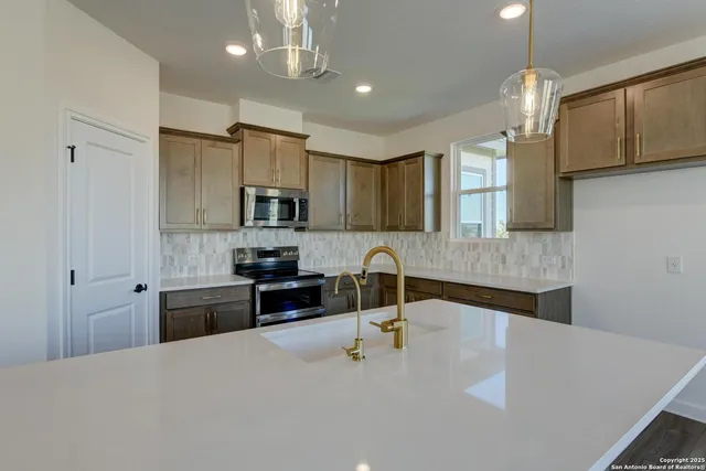 a kitchen with stainless steel appliances granite countertop a stove and a microwave