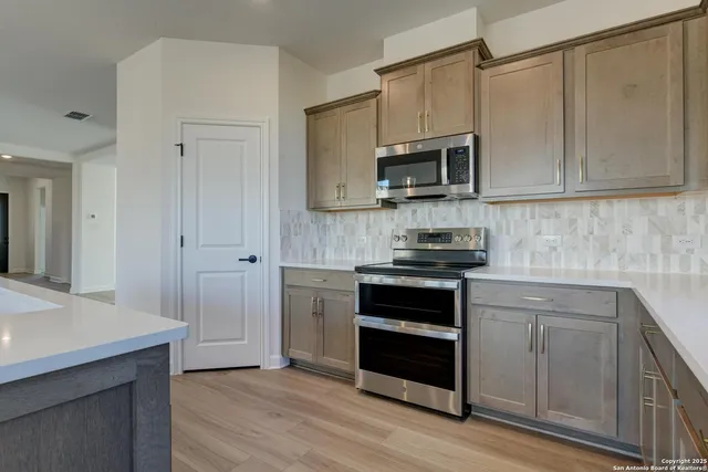 a spacious bathroom with a granite countertop sink a toilet and a mirror