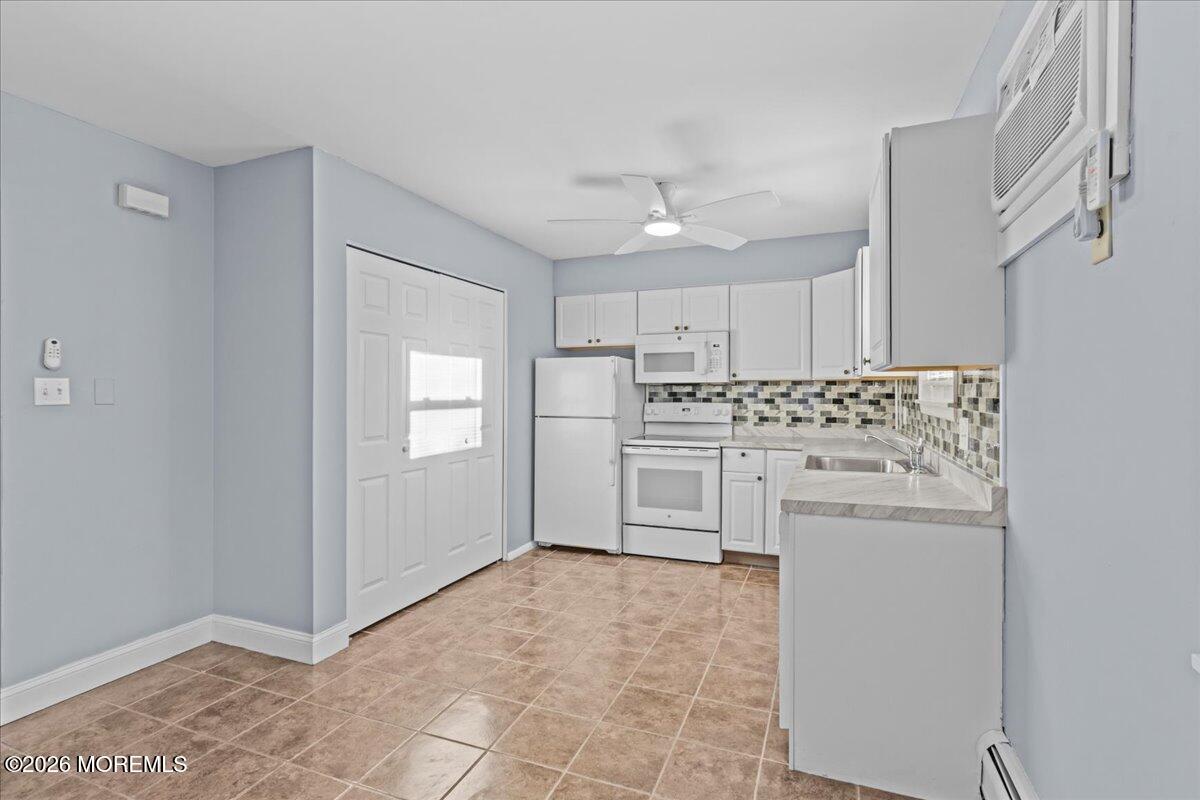417 Riverview Road Forked River, NJ 08731 - Photo 2 of 26 a kitchen with white cabinets and white appliances