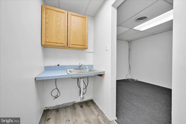 a view of a storage & utility room with a sink