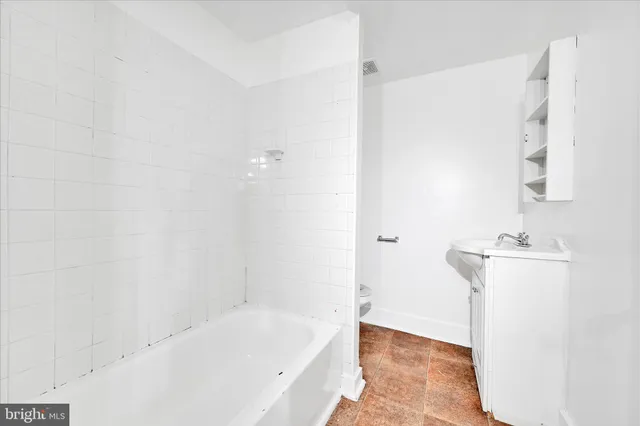 a bathroom with a bathtub and a sink