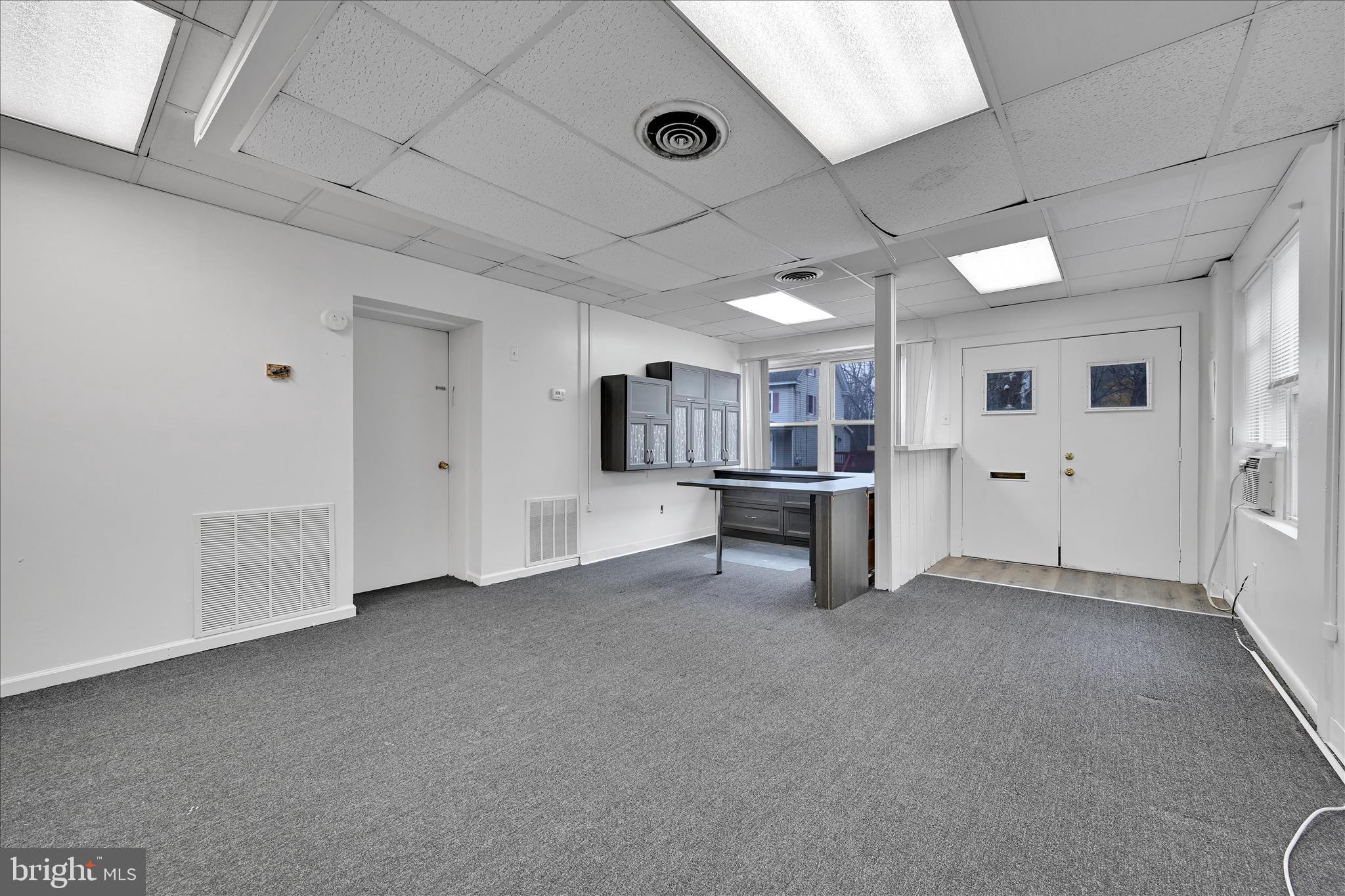 4301 Aston Mills Road Aston, PA 19014 - Photo 7 of 33 a view of an empty room with kitchen and window