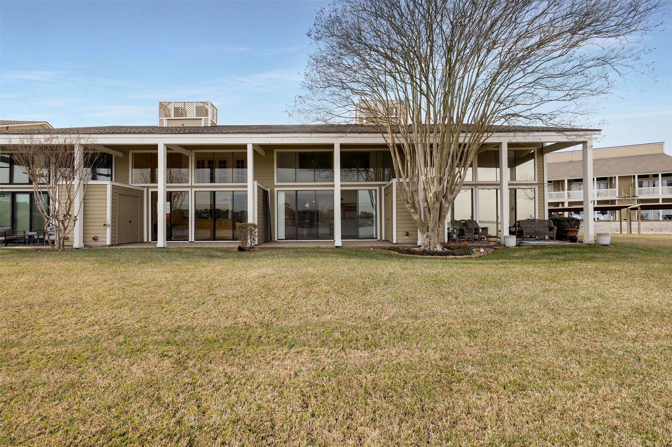 135 April Point Drive South Conroe, TX 77356 - Photo 11 of 45 View of the back patio from the lake.