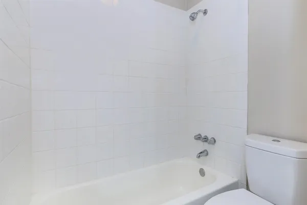 a bathroom with a bathtub and toilet