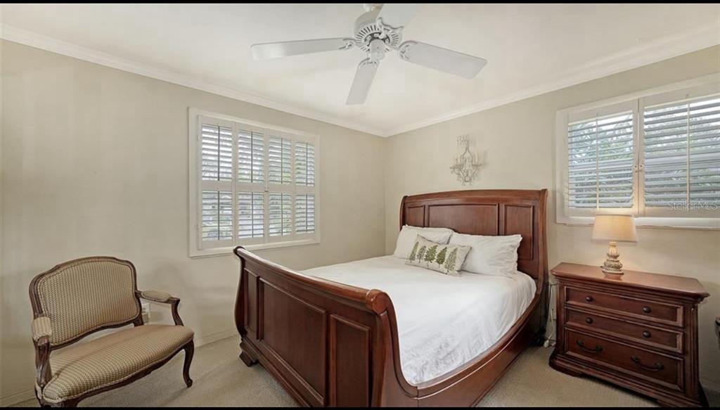 2264 Floyd Street Sarasota, FL 34239 - Photo 12 of 17 a bedroom with a bed and a chandelier