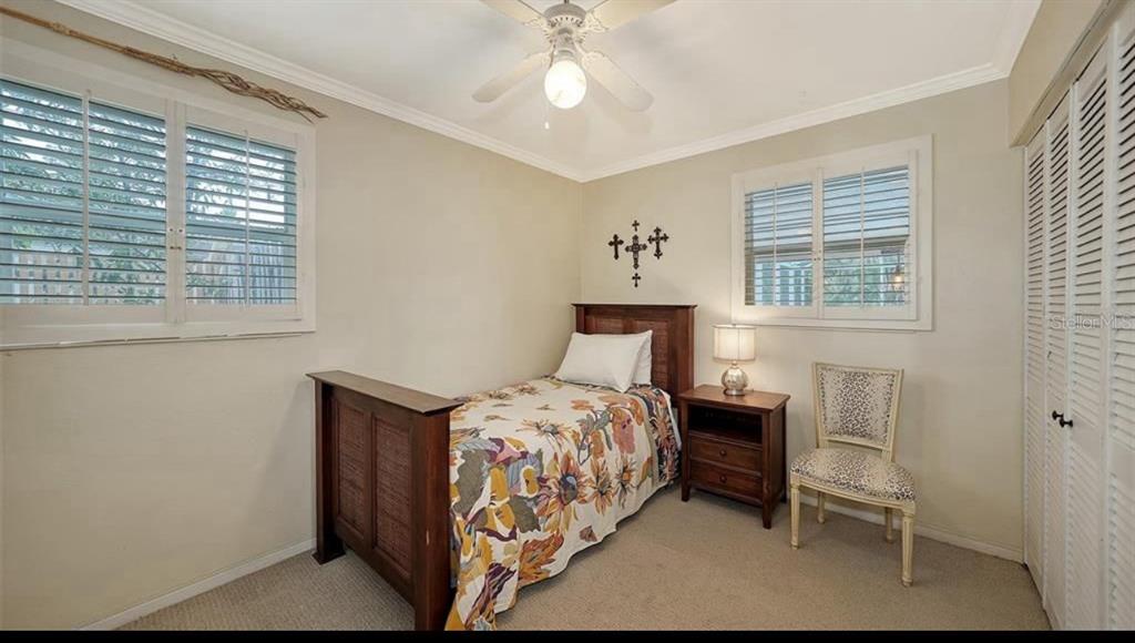 2264 Floyd Street Sarasota, FL 34239 - Photo 10 of 17 a bedroom with a bed and a chandelier