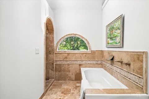 a bathroom with a bathtub and a window