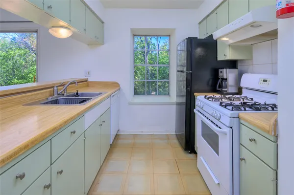 a kitchen with a sink stove and refrigerator