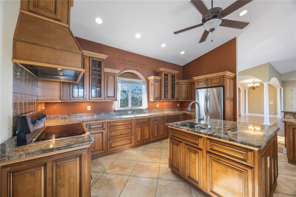 736 Pruitt Drive Madeira Beach, FL 33708 - Photo 13 of 42 a kitchen with stainless steel appliances granite countertop a sink and cabinets