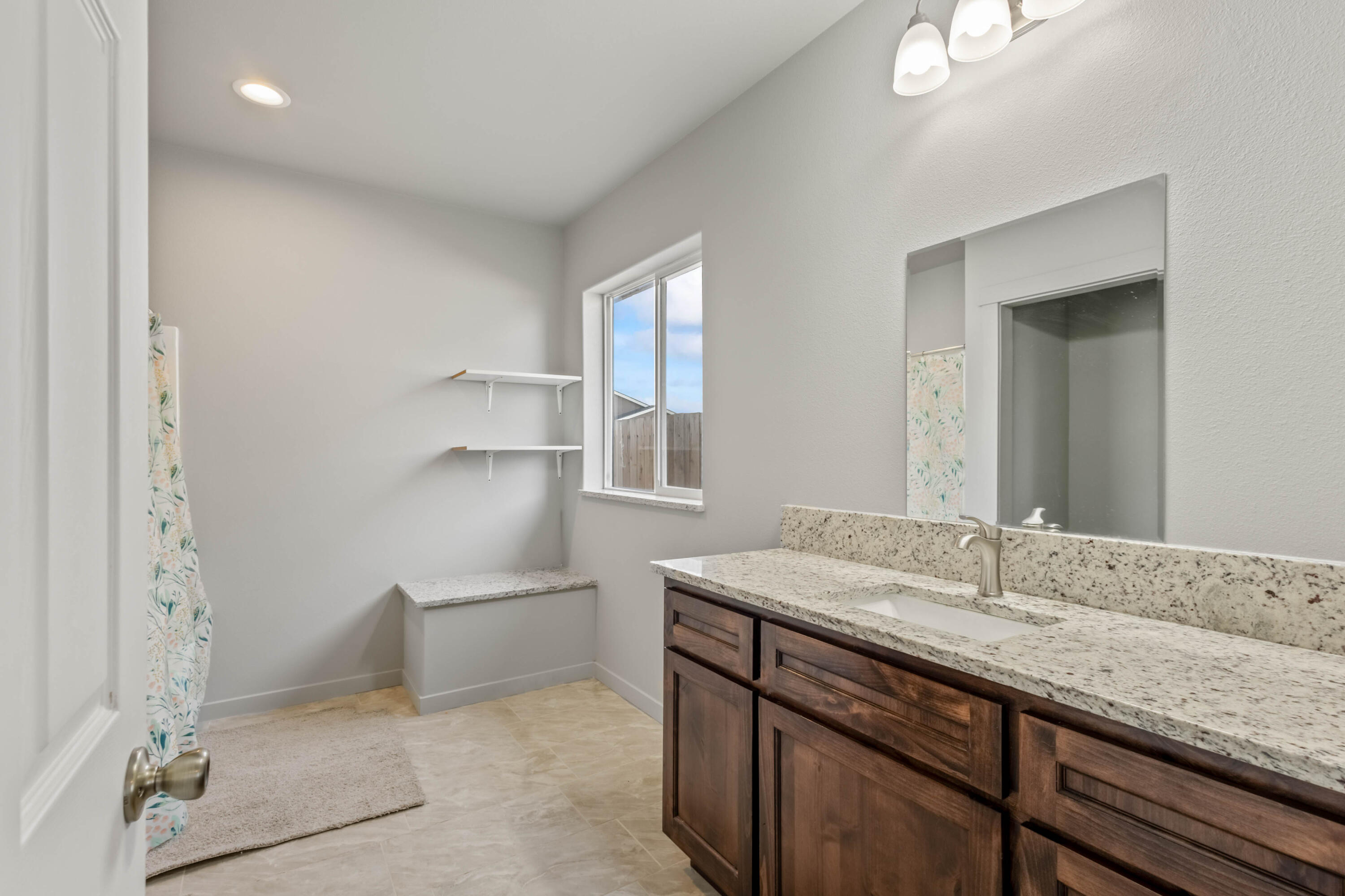 539 Leisek Way Madras, OR 97741 - Photo 13 of 35 a bathroom with a granite countertop sink and a mirror