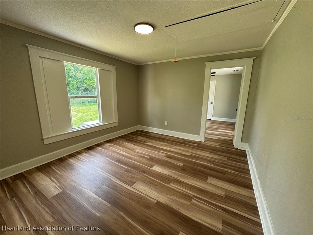 111 D Street Frostproof, FL 33843 - Photo 11 of 40 a view of an empty room with wooden floor and a window