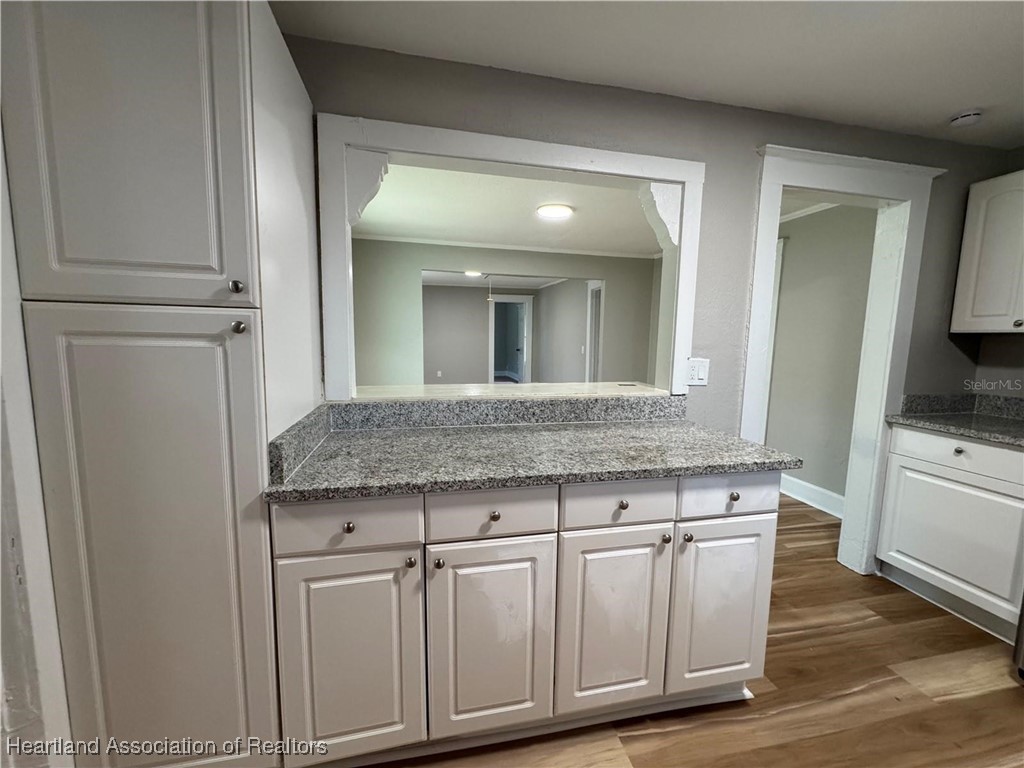111 D Street Frostproof, FL 33843 - Photo 22 of 40 a bathroom with a granite countertop sink and a mirror