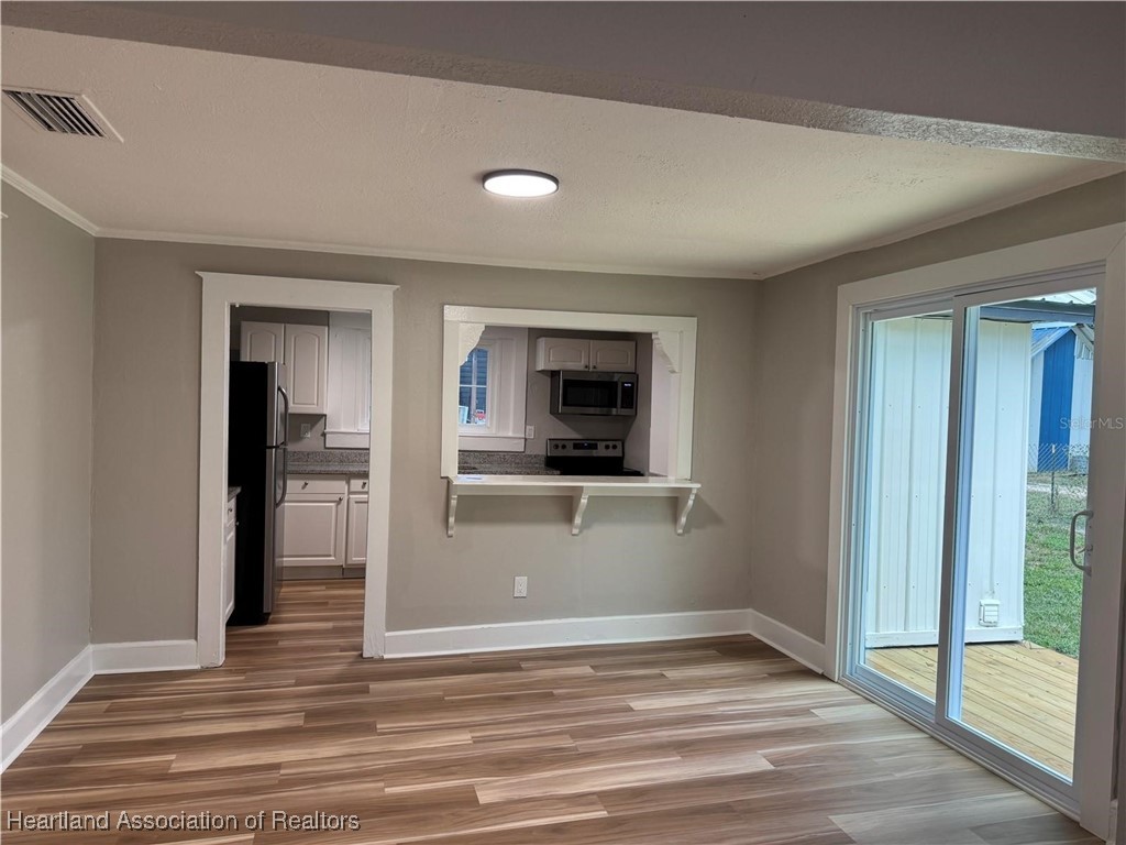 111 D Street Frostproof, FL 33843 - Photo 25 of 40 a view of a hallway view with wooden floor and a living room