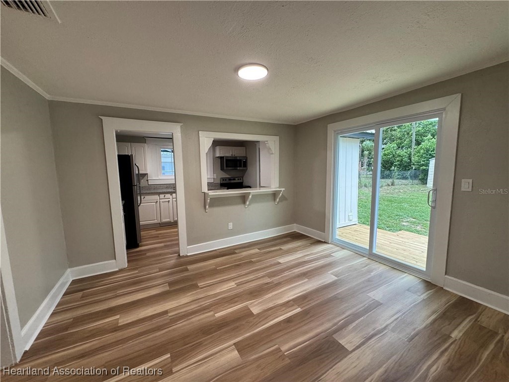 111 D Street Frostproof, FL 33843 - Photo 27 of 40 a view of a livingroom with wooden floor and a kitchen