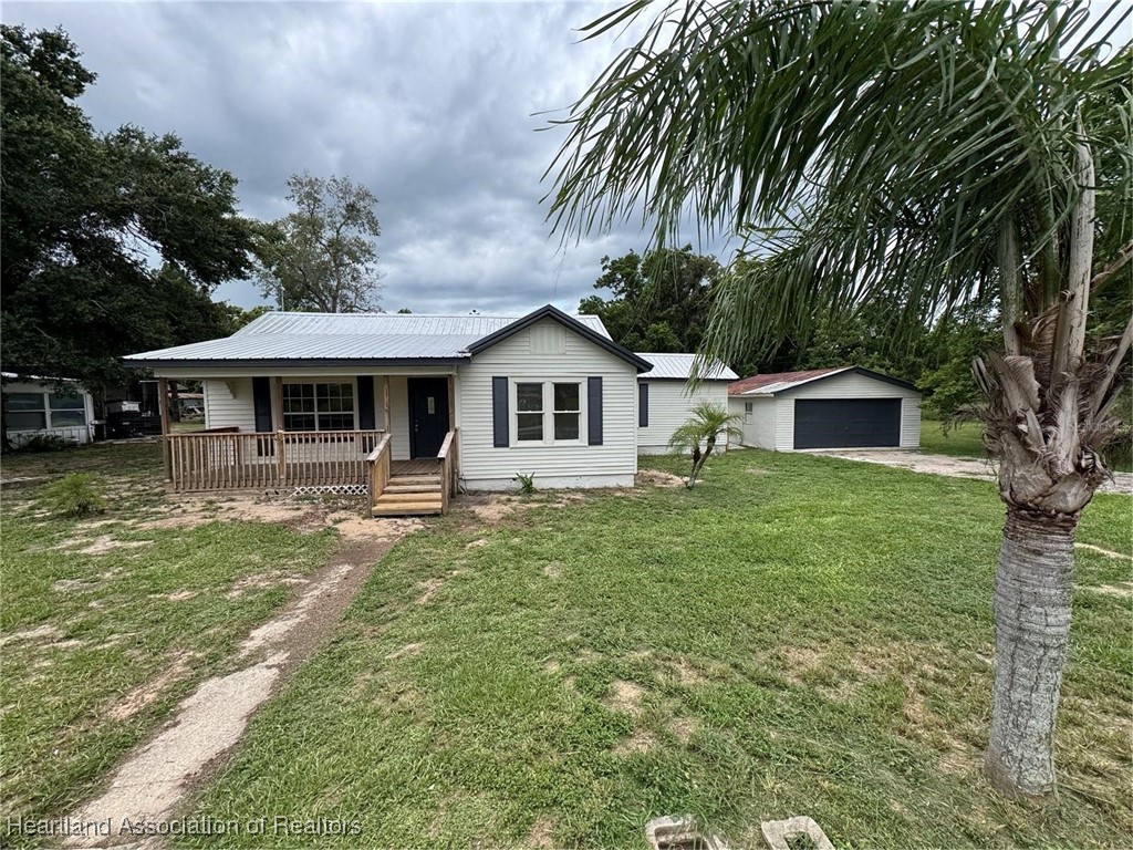 111 D Street Frostproof, FL 33843 - Photo 39 of 40 a front view of a house with a garden
