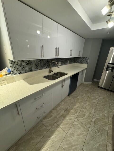 4167 Haverhill Road, Unit 1107 West Palm Beach, FL 33417 - Photo 2 of 13 a kitchen with a sink and cabinets