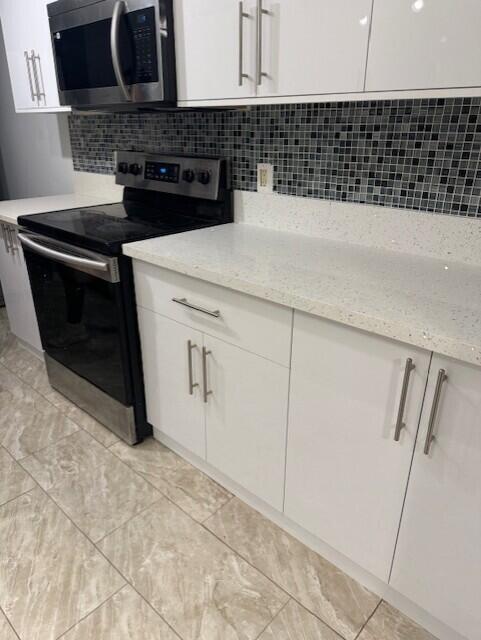 4167 Haverhill Road, Unit 1107 West Palm Beach, FL 33417 - Photo 4 of 13 a kitchen with a sink and cabinets