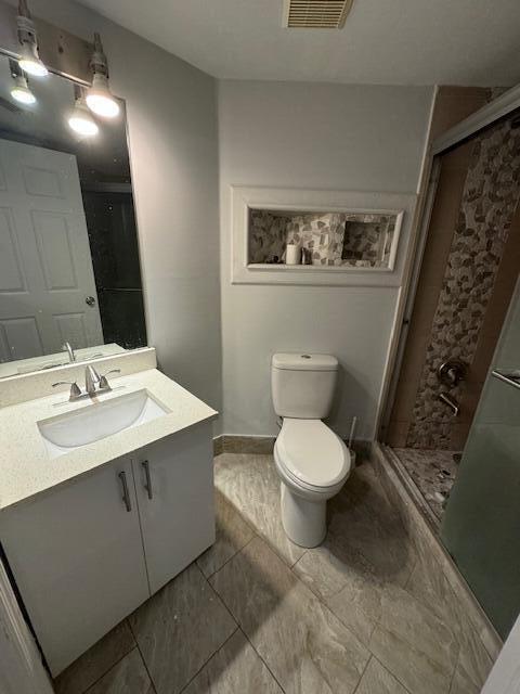 4167 Haverhill Road, Unit 1107 West Palm Beach, FL 33417 - Photo 6 of 13 a bathroom with a toilet sink and mirror