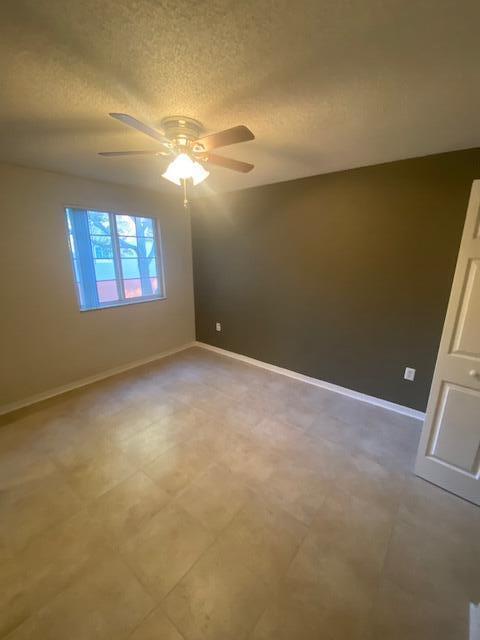 4167 Haverhill Road, Unit 1107 West Palm Beach, FL 33417 - Photo 10 of 13 a view of an empty room with a window