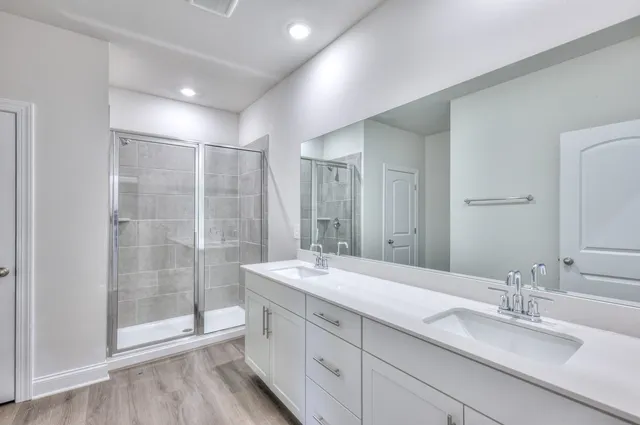 a bathroom with double sink and a mirror