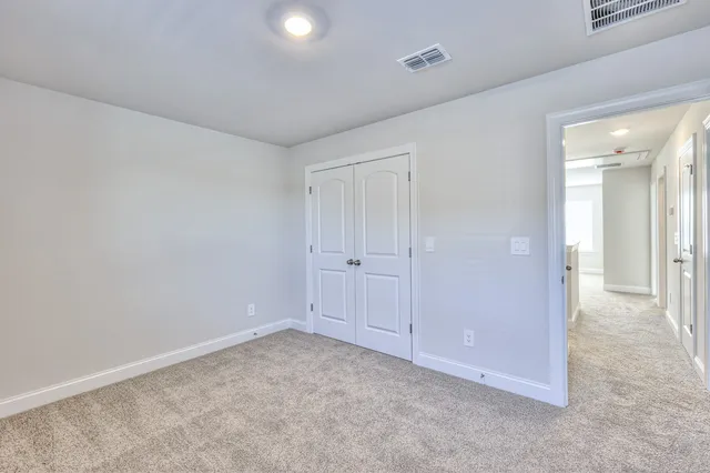 an empty room with closet area