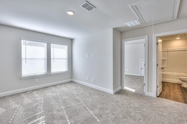 an empty room with windows and entrance