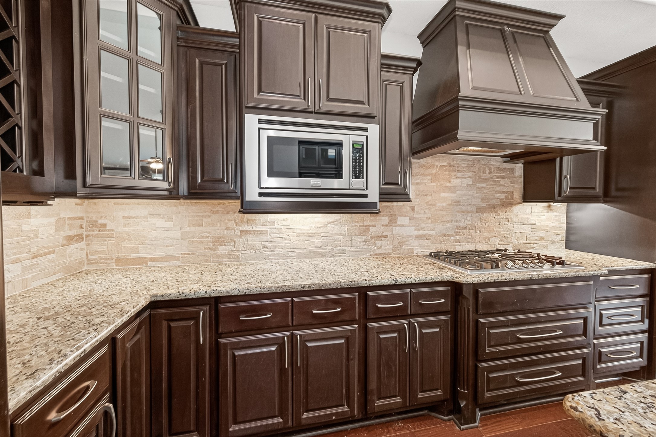 24122 Valencia Ridge Lane Katy, TX 77494 - Photo 15 of 48 a kitchen with granite countertop a stove top oven cabinetry and granite counter tops