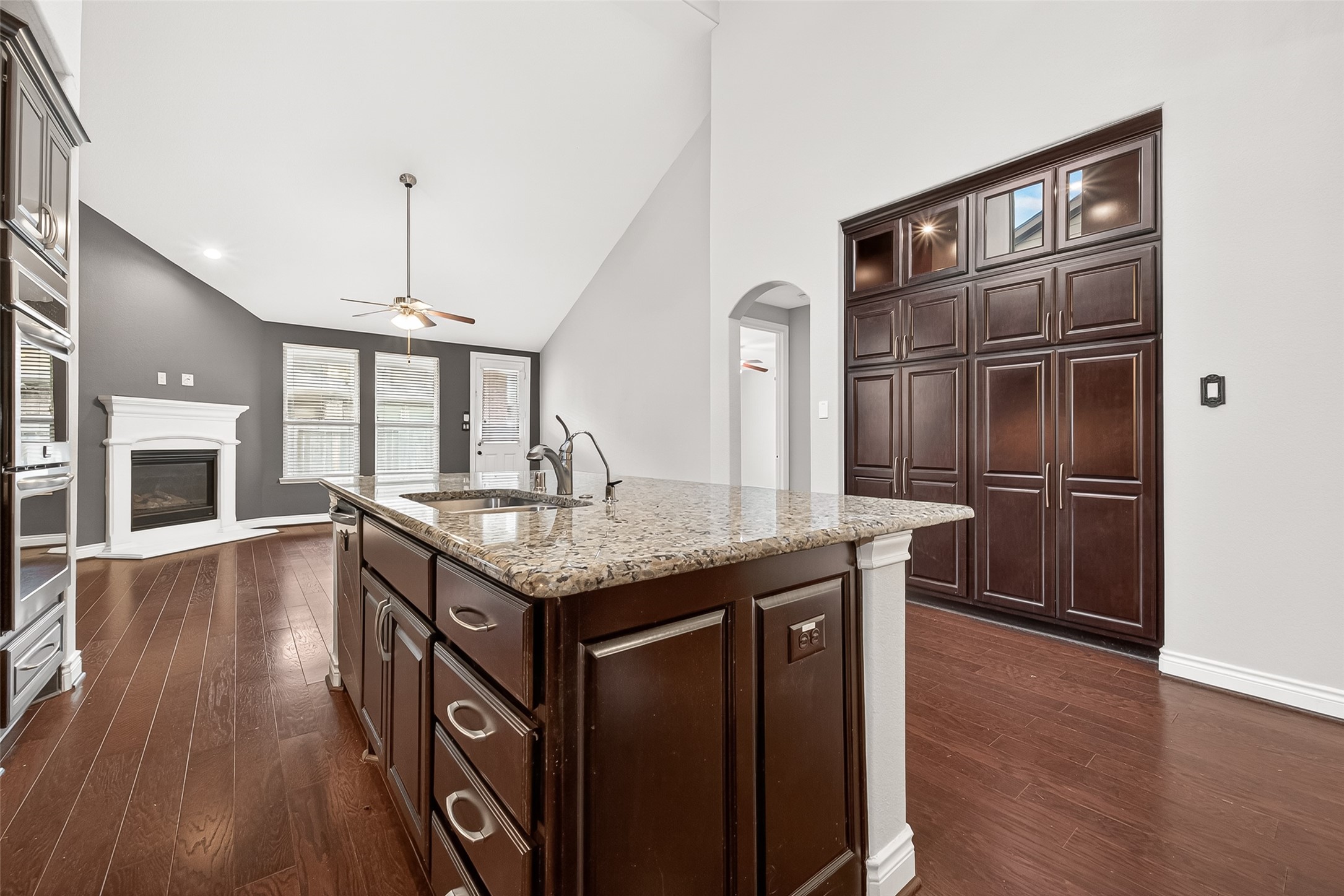 24122 Valencia Ridge Lane Katy, TX 77494 - Photo 16 of 48 a kitchen with granite countertop a oven a refrigerator and wooden floor