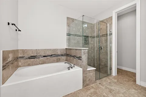 a bathroom with a sink a toilet a mirror and shower