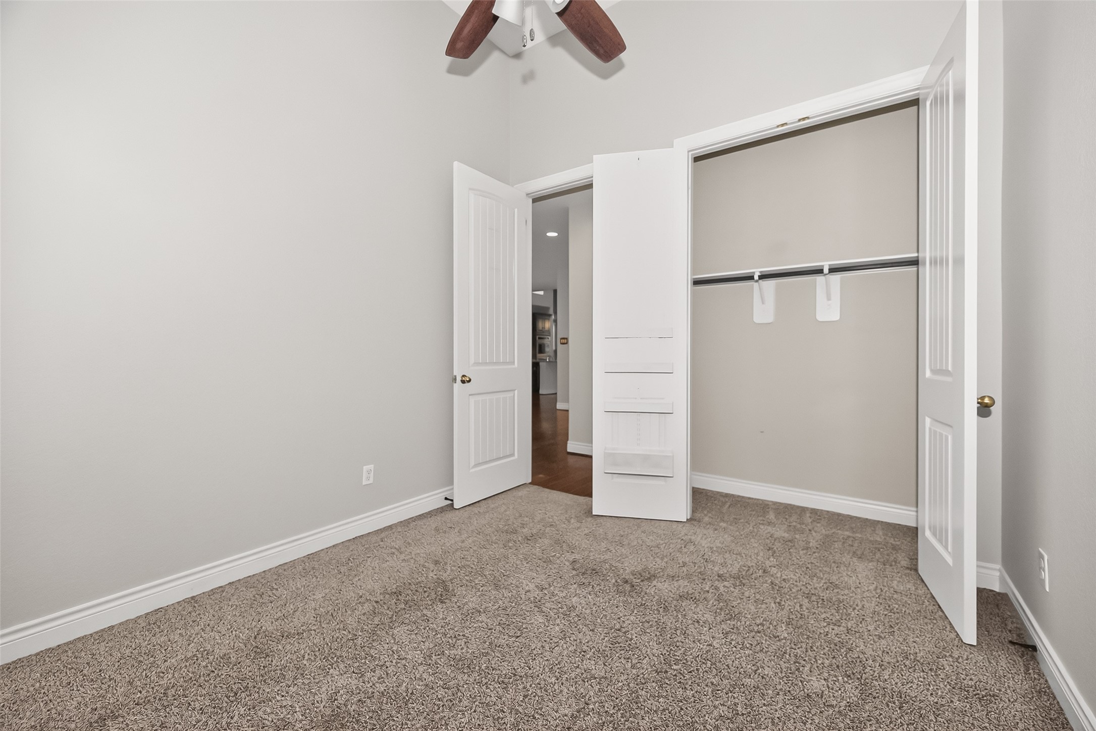 24122 Valencia Ridge Lane Katy, TX 77494 - Photo 27 of 48 an empty room with closet and a ceiling fan