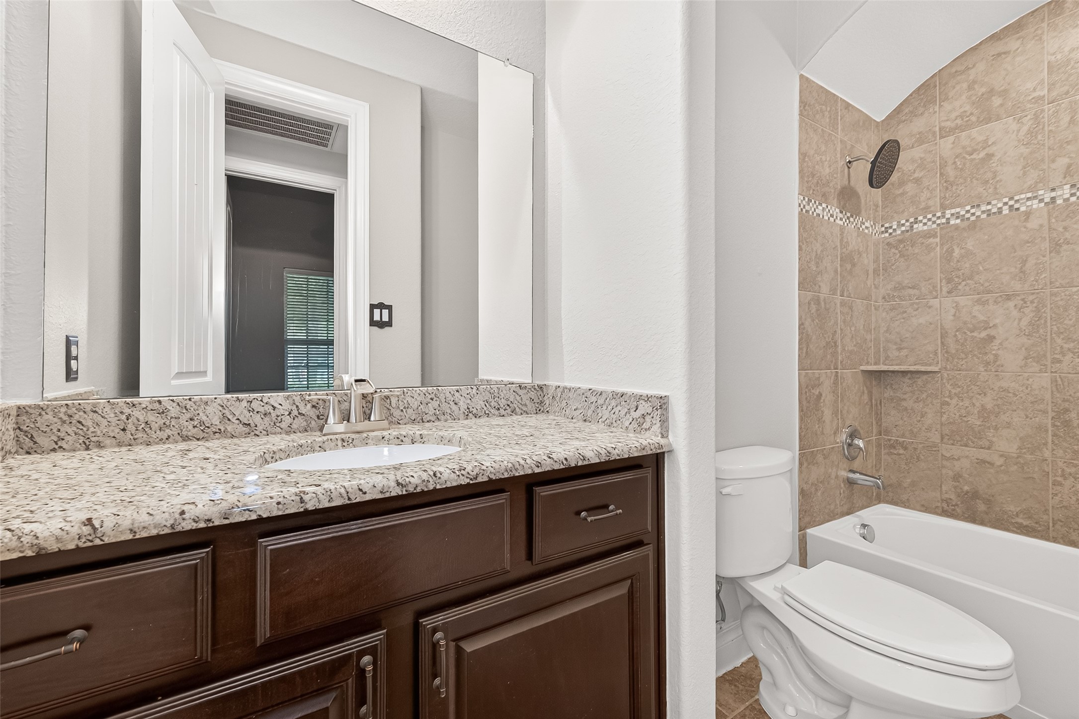 24122 Valencia Ridge Lane Katy, TX 77494 - Photo 29 of 48 a bathroom with a granite countertop sink a toilet and shower