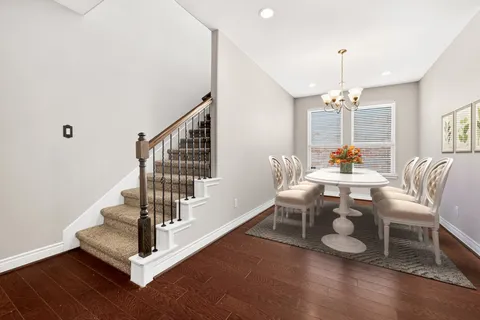 a kitchen with granite countertop a oven a refrigerator and wooden floor