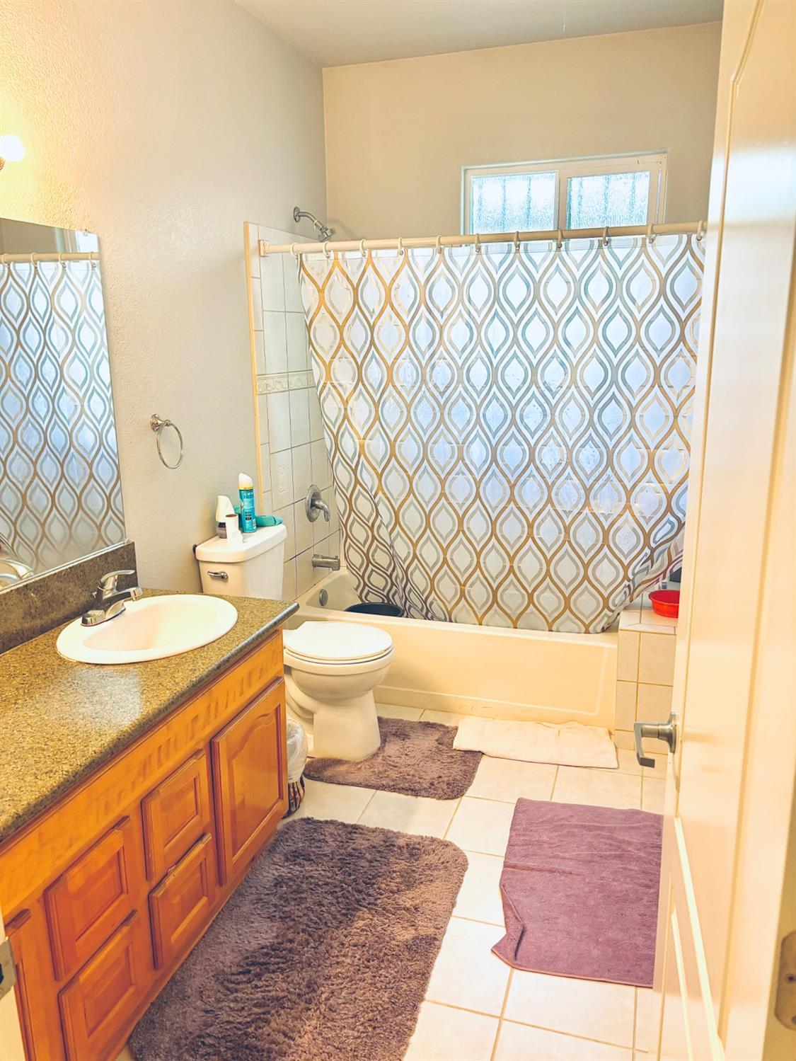 3416 Rio Linda Boulevard Sacramento, CA 95838 - Photo 8 of 13 a bathroom with a granite countertop sink and a mirror