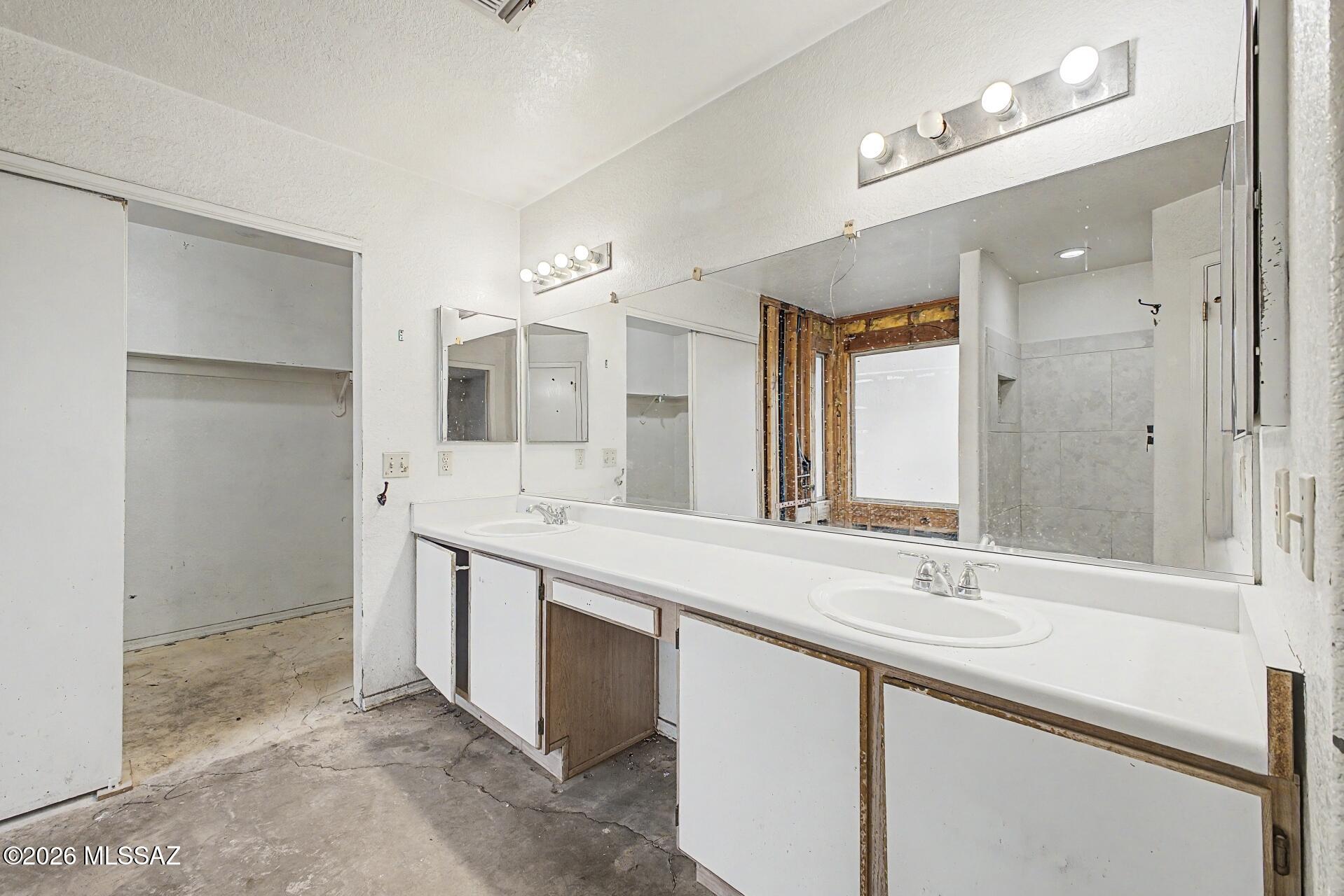9810 East Stonehaven Way Tucson, AZ 85747 - Photo 18 of 27 a bathroom with a double vanity sink mirror and double