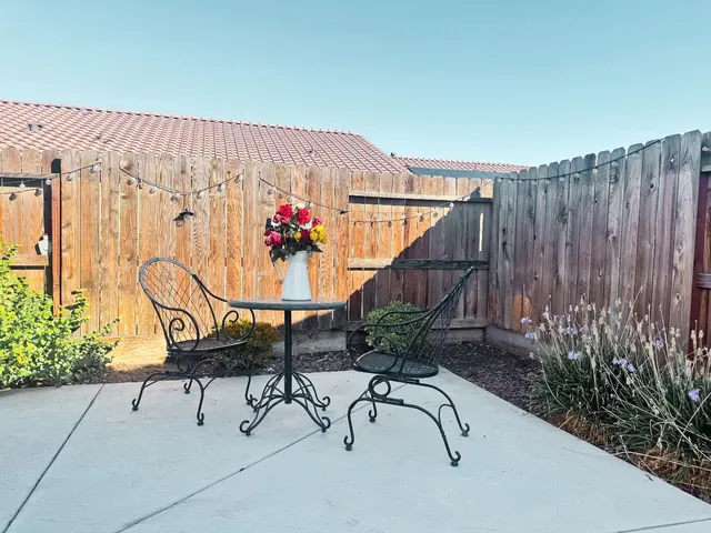 a view of patio with a table and chairs