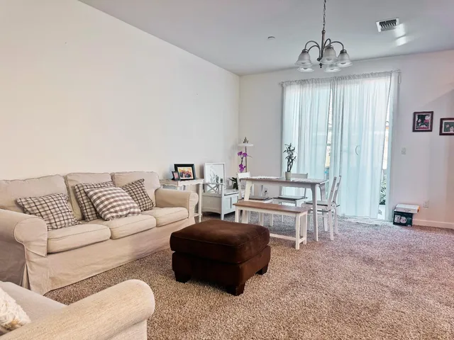 a living room with furniture and large windows