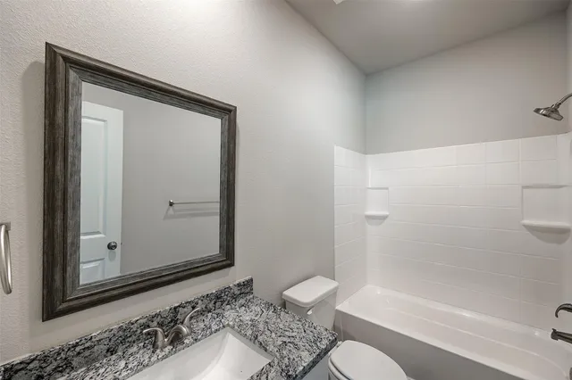 a bathroom with a shower and a toilet sink