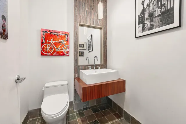 a bathroom with a toilet a sink and a mirror