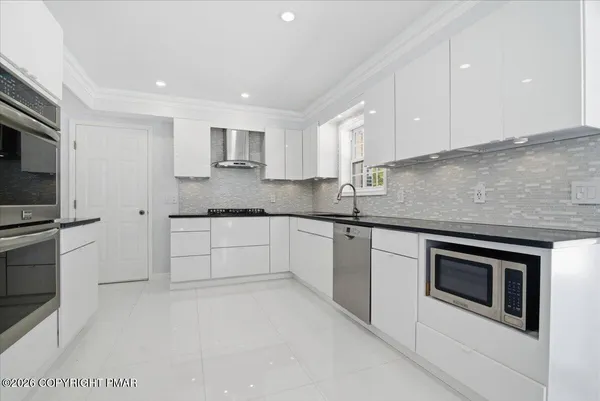 a large white bed in a white room