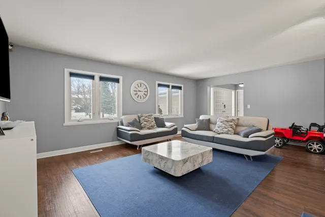 a living room with furniture window and wooden floor
