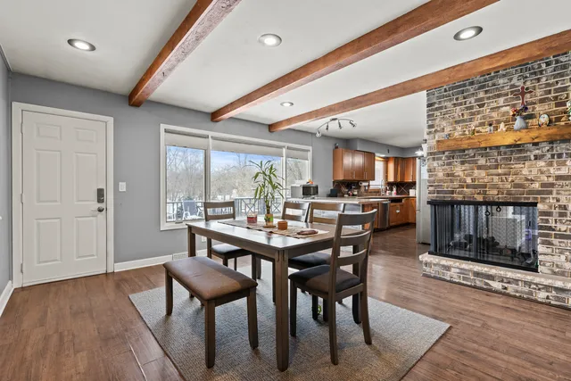 a dining room with furniture and wooden floor