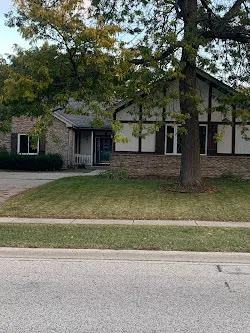 a front view of a house with a yard garage and outdoor seating
