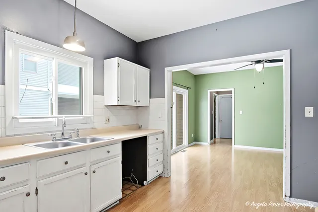 a spacious bathroom with a double vanity sink a mirror and a shower