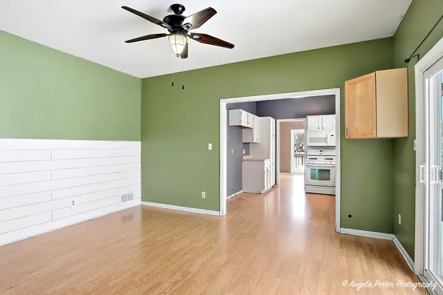 a view of a room with closet and a ceiling fan