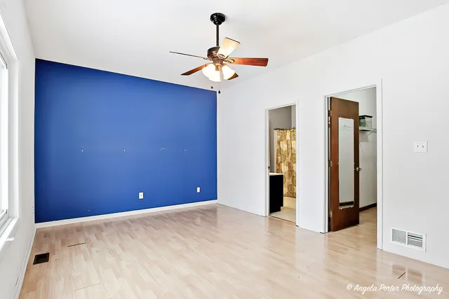 a view of a chandelier fan and entryway