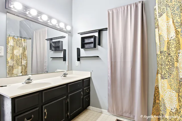 a bathroom with a double vanity sink and a mirror