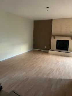 a view of an empty room with a fireplace