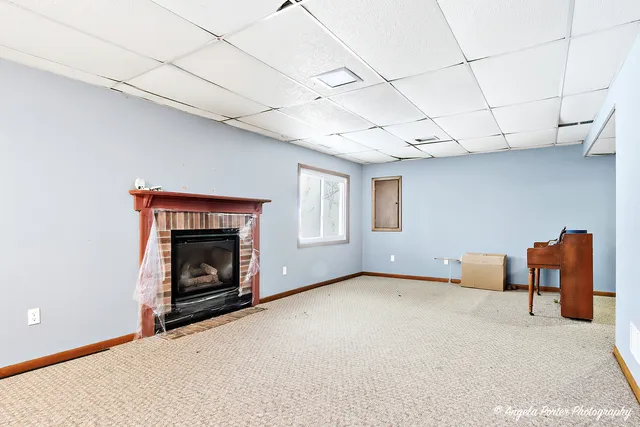 a view of empty room with a fireplace